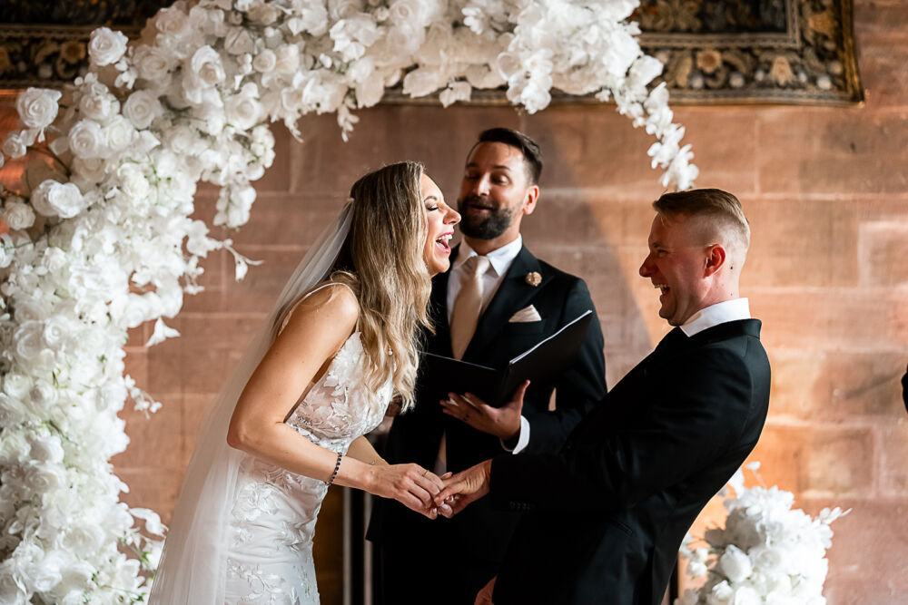 wedding ceremony, couple laughing during vows, peckforton castle