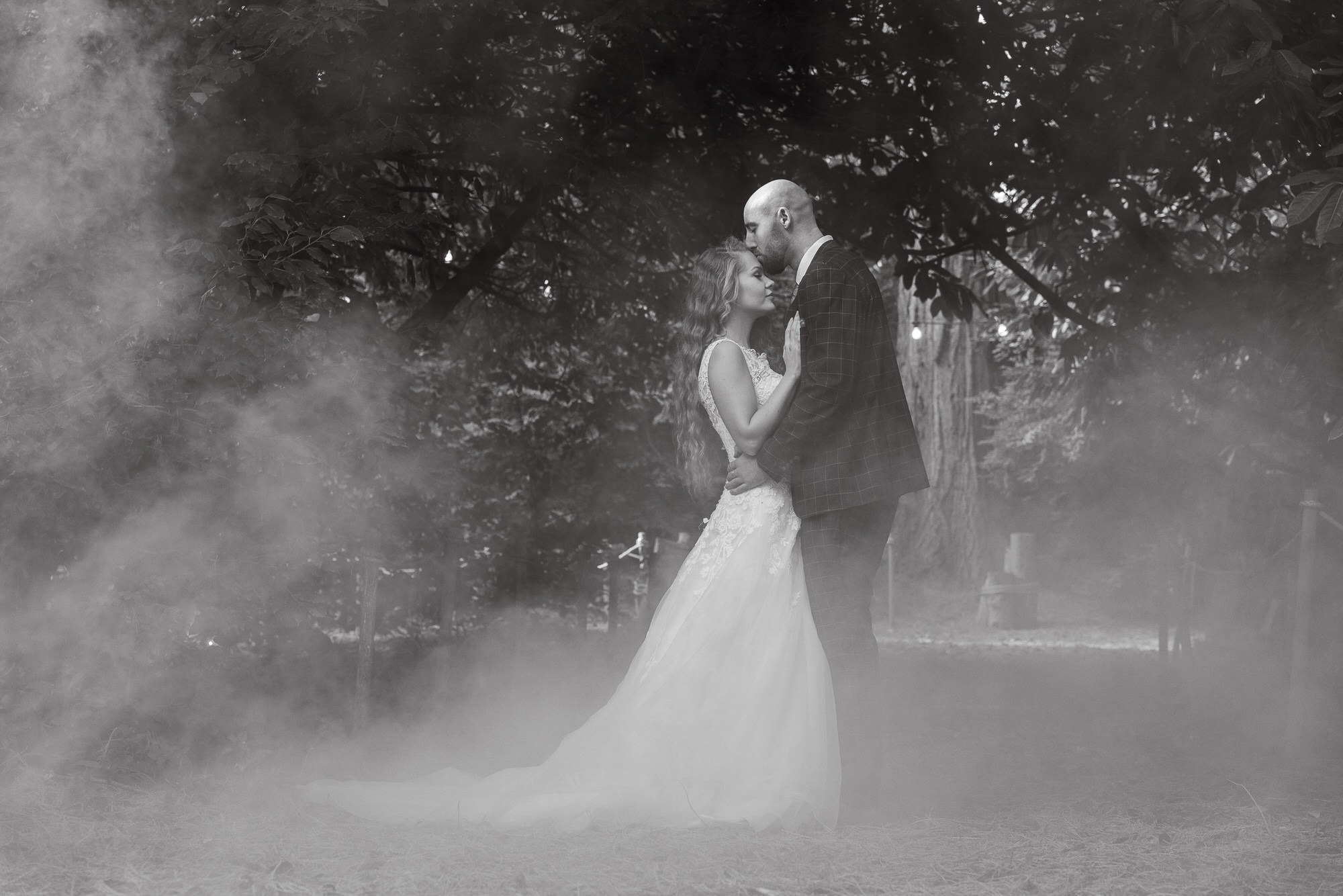 couple kiss with smoke from a smoke flare around them