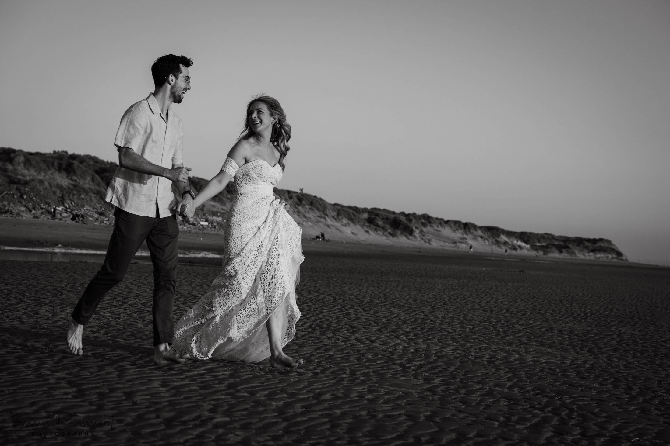 couples running together on the beach during a pre-wedding couples photoshoot